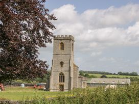 A church with a tower in a rural landscape at The End in Langport