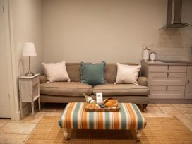 A living room with a sofa and coffee table at The End Low Ham near Langport