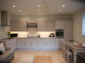 A kitchen with cabinets and appliances at The End in Low Ham near Langport