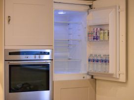 A refrigerator and oven in a kitchen at The End in Low Ham near Langport