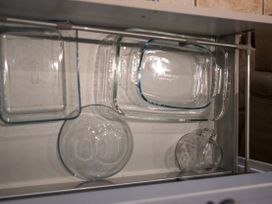 A kitchen drawer with glass containers and bowls at The End in Low Ham near Langport