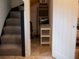 A hallway with stairs and storage at The End in Low Ham near Langport