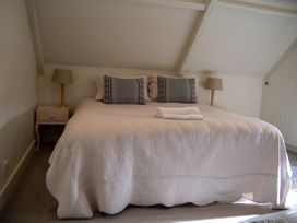 A bedroom with a bed and side table at The End in Low Ham near Langport