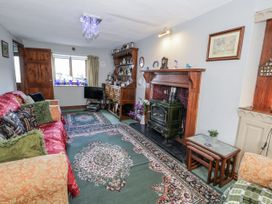A living room with a fireplace and sofa at The Old Post Office in null