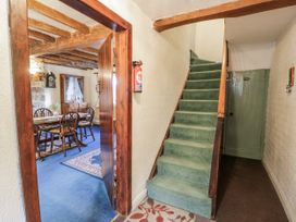 A hallway with a staircase leading to upper floors at The Old Post Office in null