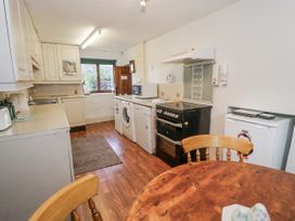 A kitchen with appliances and a table at The Old Post Office in null
