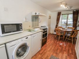 A kitchen with appliances and dining area at The Old Post Office null