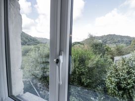 A view from a window showing mountains and trees at The Old Post Office in null