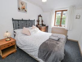 A bedroom with a bed and nightstand at The Old Post Office in null
