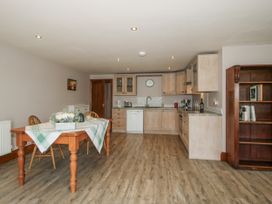 A kitchen with a dining table and chairs at Bluebell Cottage