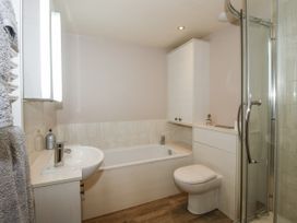 A bathroom with a bathtub, shower, sink, and toilet at Bluebell Cottage