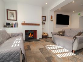 A living room with a fireplace and two sofas at Lenny's Place in Watchet