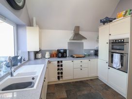A kitchen with countertops and appliances at Lenny's Place in Watchet