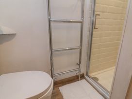 A bathroom with a shower and towel rail at Lenny's Place in Watchet