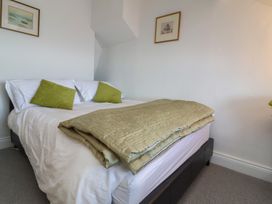 A bedroom with a bed and wall art at Lenny's Place in Watchet