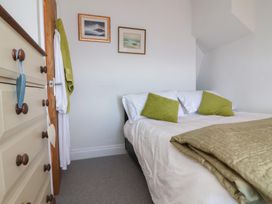 A bedroom with a bed and art on the wall at Lenny's Place in Watchet