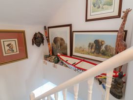 A staircase with various artworks and sculptures at Lenny's Place in Watchet