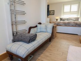 A bedroom with a bed and a sofa at Lenny's Place in Watchet