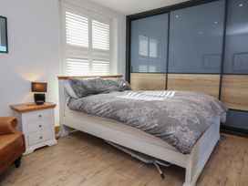 A bedroom with a bed and bedside table at Lenny's Place Watchet