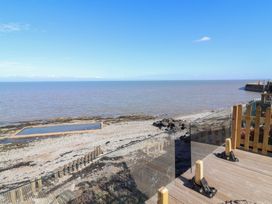 A beach view with water and rocks at Lenny's Place Watchet
