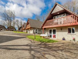 An outdoor area with cabins and a gravel driveway at Mayfly Lodge St Tudy