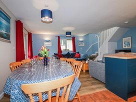 A dining area with a table and chairs at Mayfly Lodge St Tudy