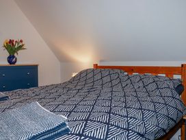 A bedroom with a bed and flowers at Mayfly Lodge in St Tudy