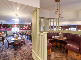 A dining room with tables and chairs at Mayfly Lodge St Tudy