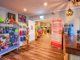 An indoor area with a snack menu and toy display at Mayfly Lodge in St Tudy
