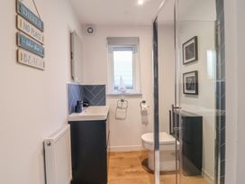 A bathroom with a wash basin and shower at Mayfly Lodge in St Tudy
