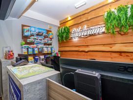 A reception area with a desk and brochures at Mayfly Lodge in St Tudy