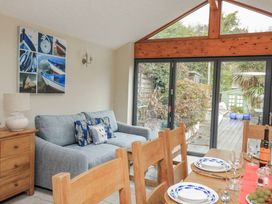 A dining room with a sofa and a dining table at Shipwrights in Salcombe