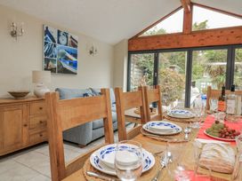 A dining room with a table set for meals at Shipwrights in Salcombe
