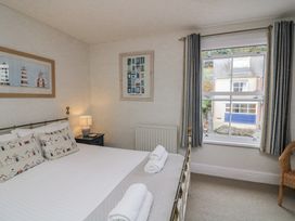 A bedroom with a bed and window at Shipwrights in Salcombe