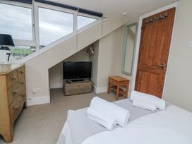 A bedroom with a television and dresser at Shipwrights in Salcombe