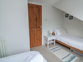 A bedroom with a single bed and nightstand at Shipwrights in Salcombe