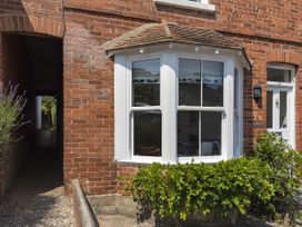 A brick exterior with windows and a door at Shipwrights in Salcombe