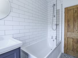 A bathroom with a bathtub and a shower at Shipwrights 11 Coronation Road Salcombe