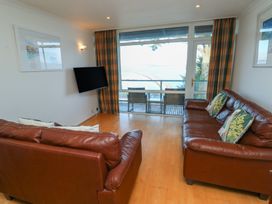 A living room with two sofas and a television at 20 Heath Court in Brixham