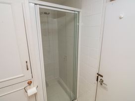 A shower enclosed in glass with a door in a bathroom at 20 Heath Court in Brixham