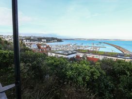 A view of a harbor with boats and buildings at 20 Heath Court in Brixham