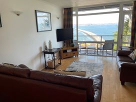 A living room with a television and seating area at Snowy Owl View at The Breakwater Brixham