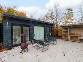 An outdoor patio with seating and wooden structure at Cabin
