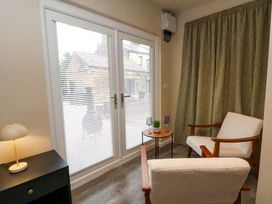 A seating area with chairs and a side table at Cabin