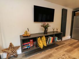 A living room with a shelf and TV at Cabin