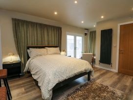 A bedroom with a bed and nightstand at the Cabin