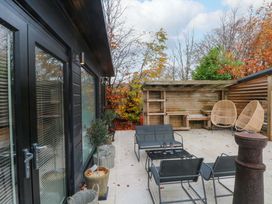 An outdoor patio area with seating and a wooden structure at Cabin 