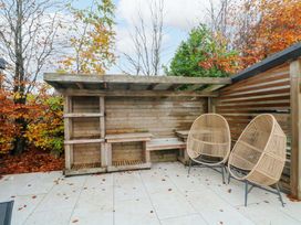 A shelter with benches and outdoor chairs at Cabin in 