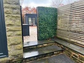 A garden with stone wall and steps at The Cabin in Loveclough near Crawshawbooth