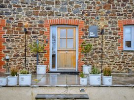 An entrance with a door and plant pots at The Dairy